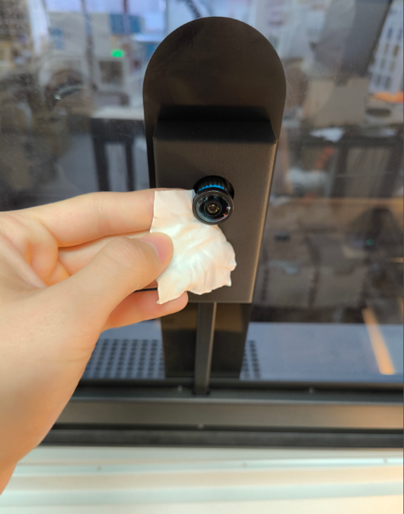 Cleaning the laser camera lens