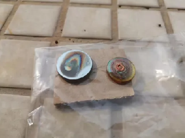 Damaged laser lenses showing cracks and burn marks