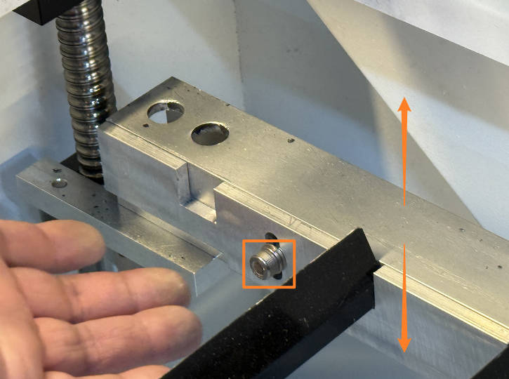 Adjusting screws on metal bar to level work platform