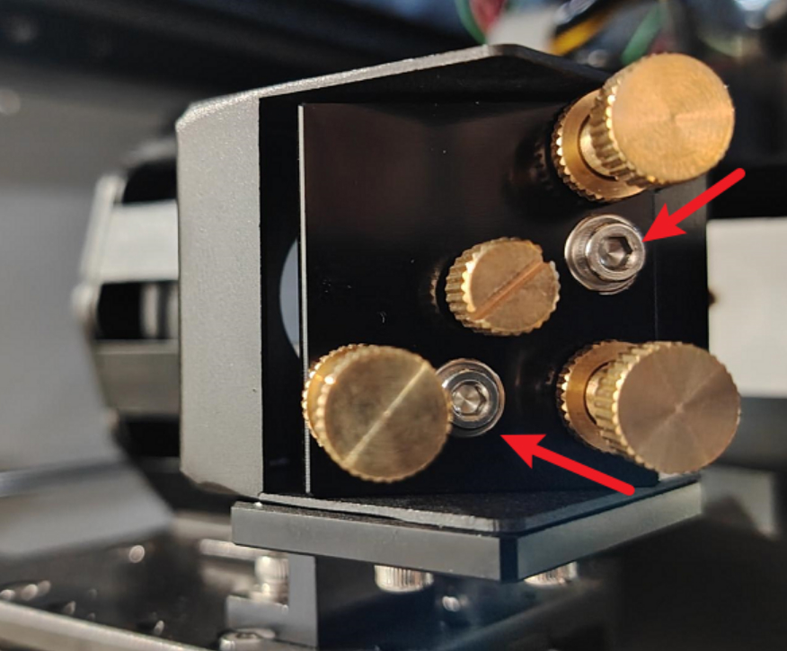 Loosening nuts to adjust light path overlap