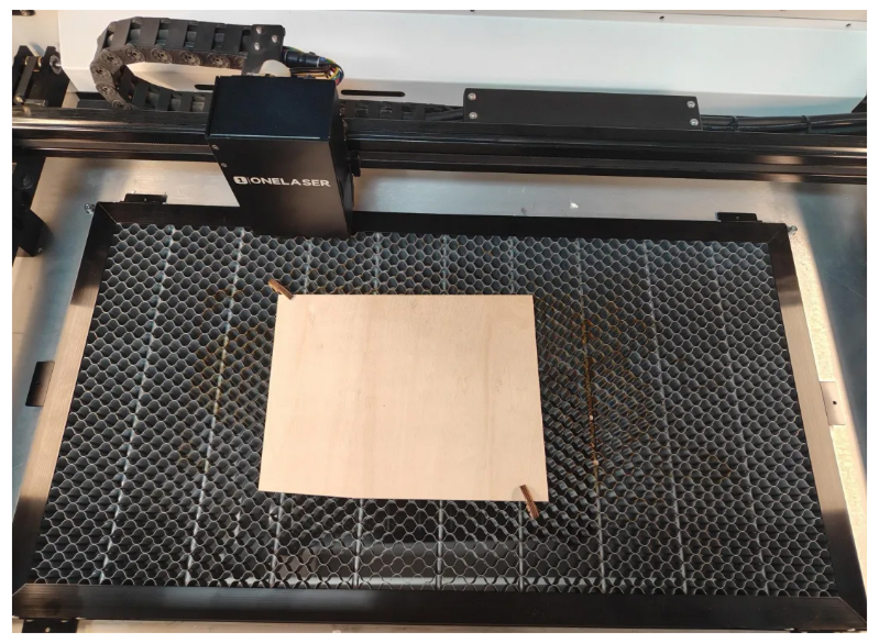 Place material on OneLaser honeycomb work bed