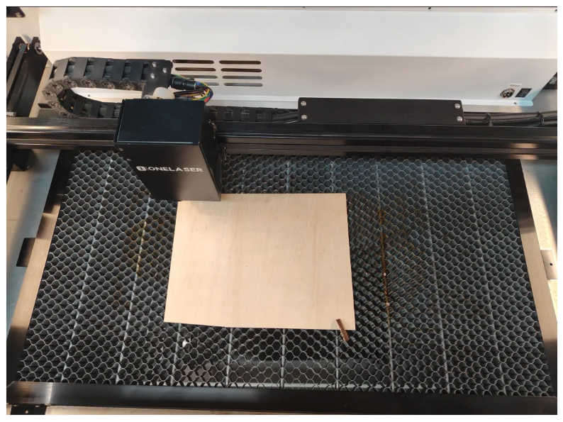 Position laser head over material surface