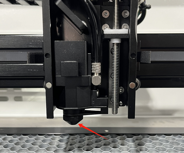 Unscrewing the X Series laser head nozzle