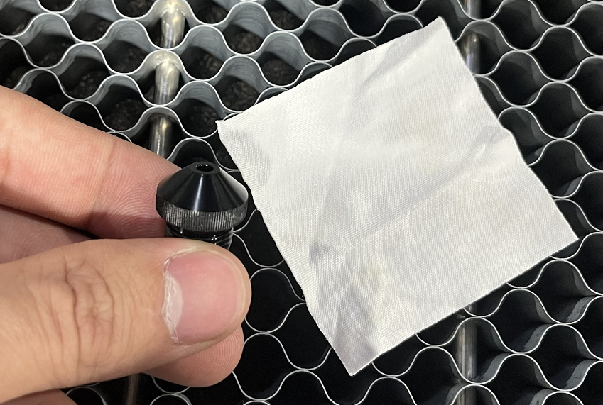 Cleaning the X Series laser head nozzle with a cloth