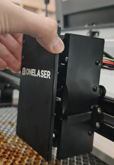 Removing the front cover of the X Series laser head bracket