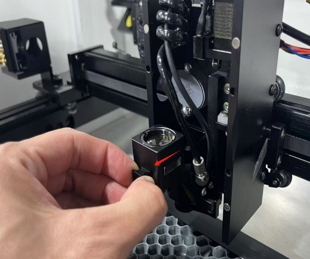 Holding and inspecting the X Series focus lens before cleaning