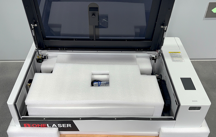 Unboxing interior items of OneLaser X Series and removing foam packaging