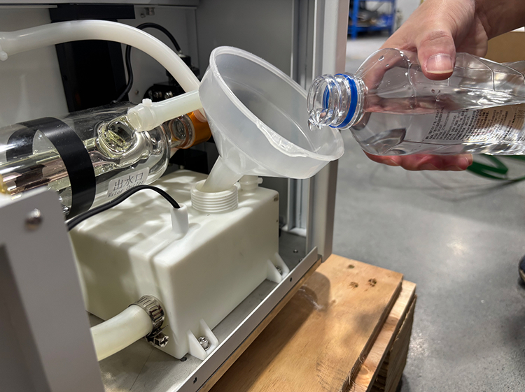 Locating water tank and adding distilled water into OneLaser XT cooling system