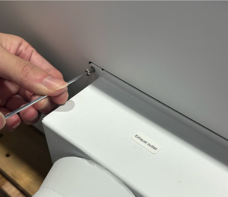 Installing the exhaust outlet onto OneLaser X Series rear panel