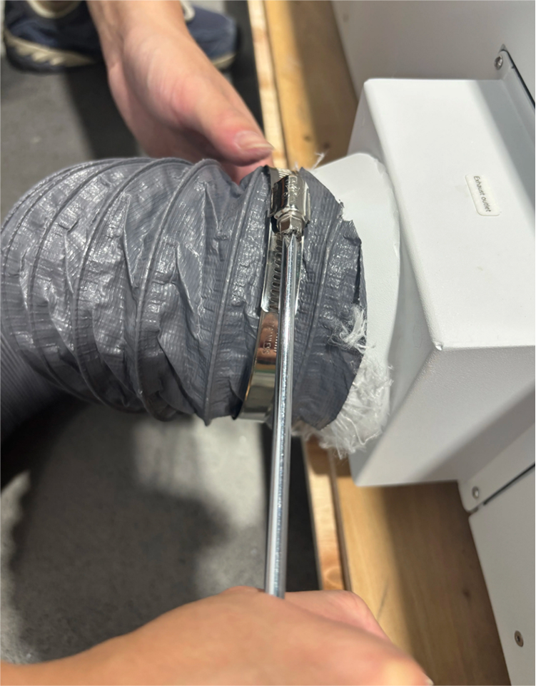 Attaching exhaust pipe to OneLaser X Series exhaust port